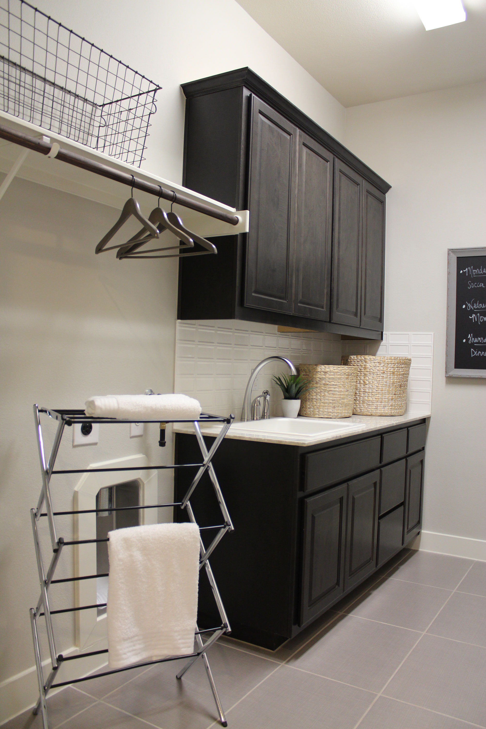 Black painted laundry room cabinets with raised panel cope and stick cabinet doors with OE3, IE1, RP1 profiles