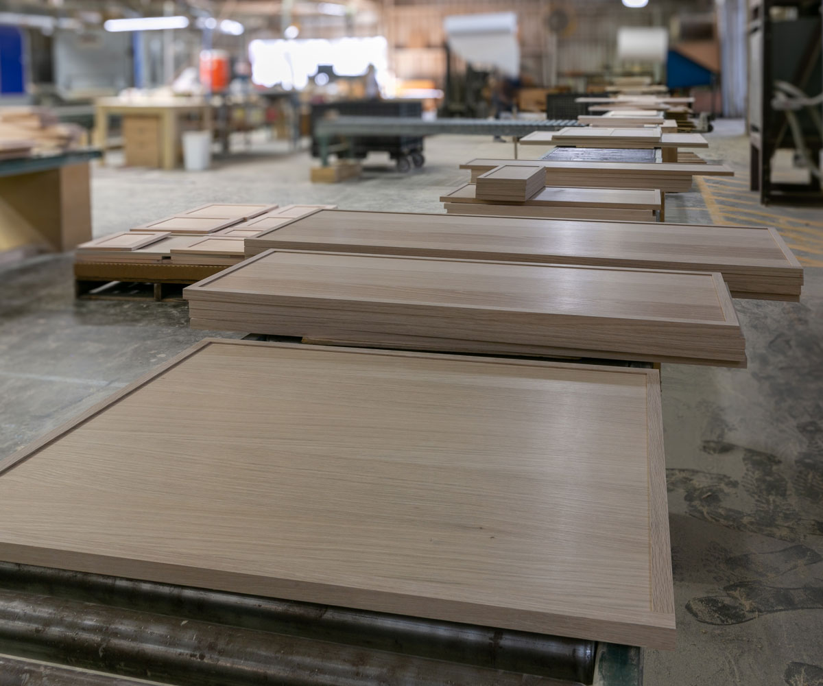 TaylorCraft cabinet door company's 4S cabinet doors on a conveyor in their woodworking shop