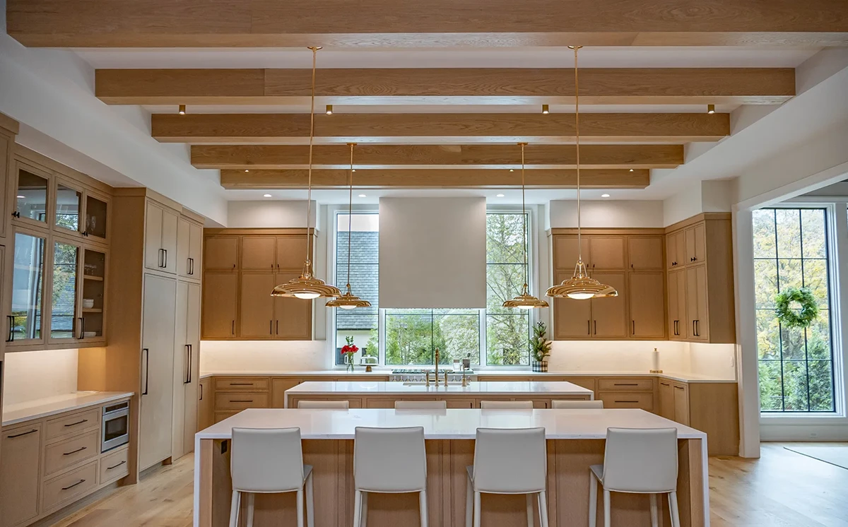 Kitchen with wood paneled double islands, 4S Slim Shaker cabinet doors, glass doors, custom appliance panels in White Oak