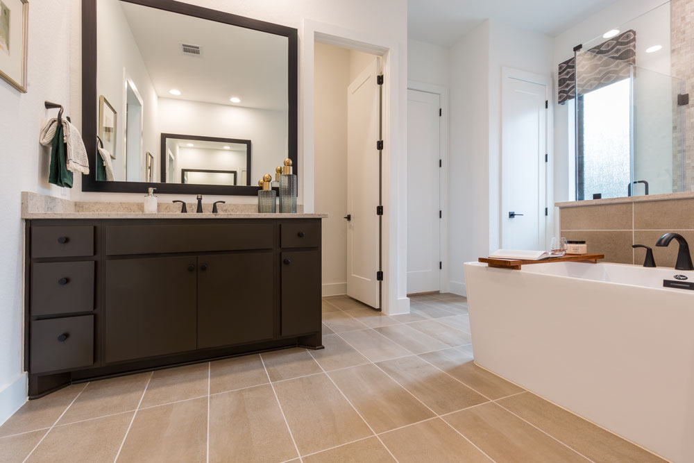 Bathroom cabinets with TaylorCraft's paint grade modern slab door painted a custom chocolate brown by customer