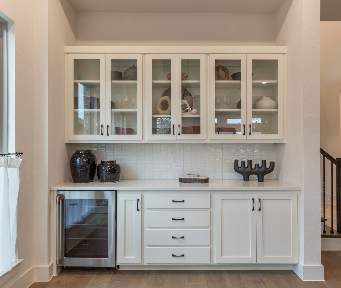 Dining room built-in buffet cabinets with TaylorCraft's cope and stick OE4, IE2 flat panel cabinet doors with glass uppers and wine beverage refrigerator