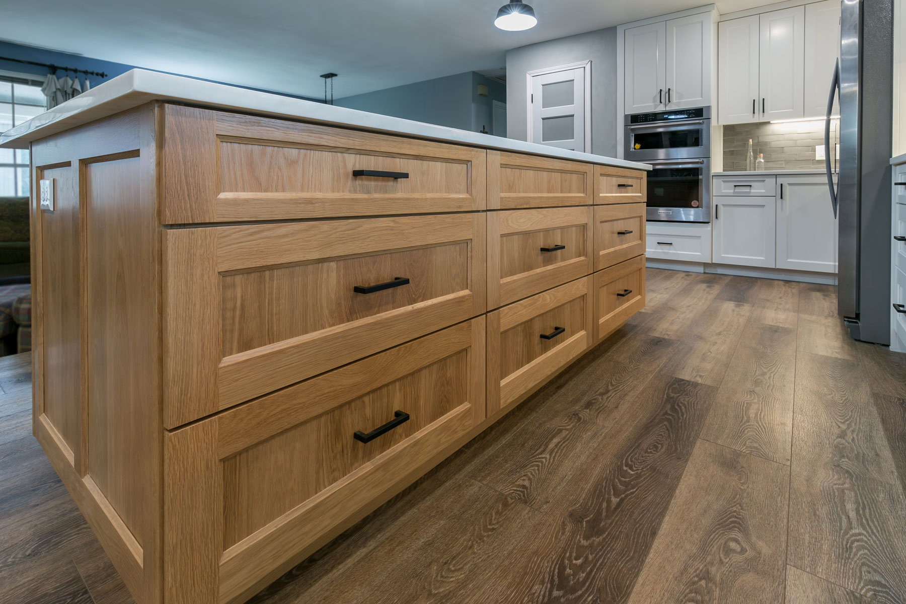 White Oak kitchen island with flat panel drawer fronts with vertical panel grain, wide stiles and rails and IE4 inside edge