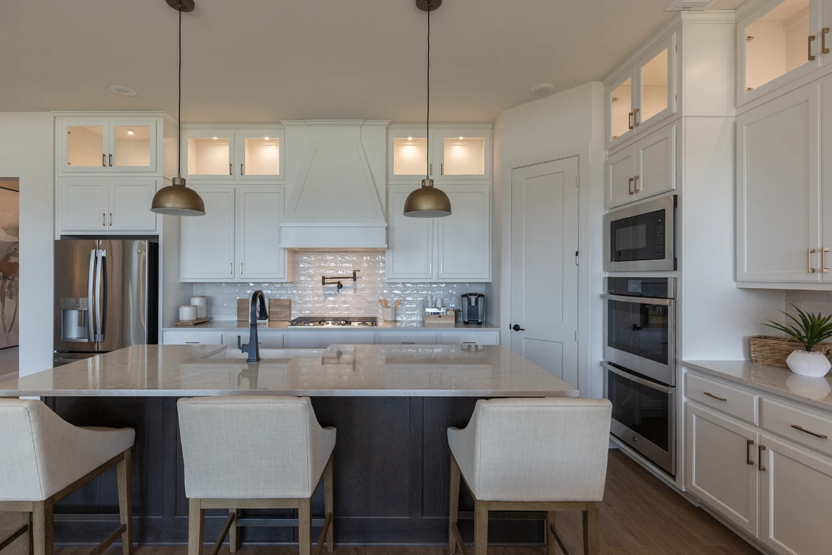 Kitchen cabinets with C101 cope and stick cabinet doors with OE3, IE1 and flat panel, slab drawer fronts with OE3 in paint grade material painted white on perimeter and stain grade beech cabinet doors and wainscot on the island
