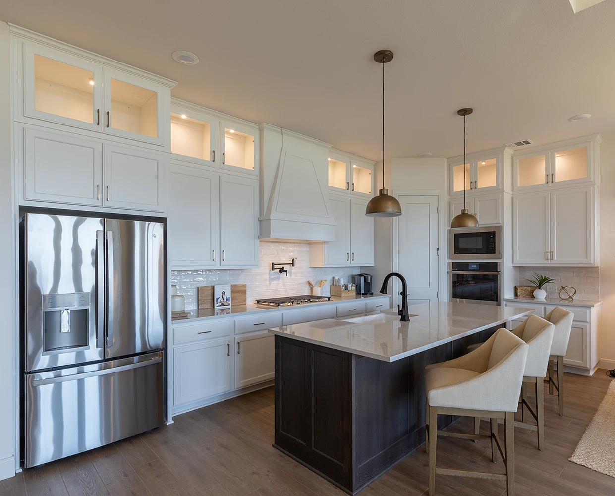 Kitchen cabinets with C101 cope and stick cabinet doors with OE3, IE1 and flat panel, glass upper cabinet doors, slab drawer fronts with OE3 in paint grade material painted white on perimeter and stain grade beech cabinet doors and wainscot on the island