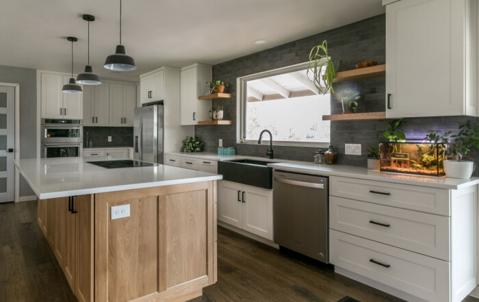 White Oak kitchen island and white perimeter cabinets with flat panel cabinet doors and drawer fronts, wide stiles, reduced rails and IE4 inside edge