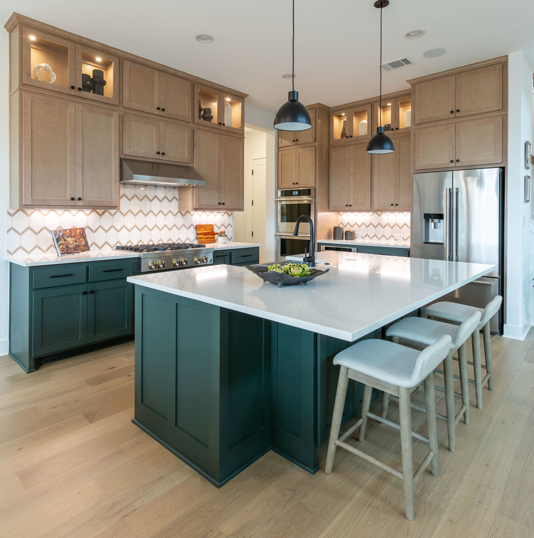 Kitchen cabinets with maple uppers and green painted base cabinets and island with OE4, IE2, flat panel Shaker style cabinet doors and glass uppers