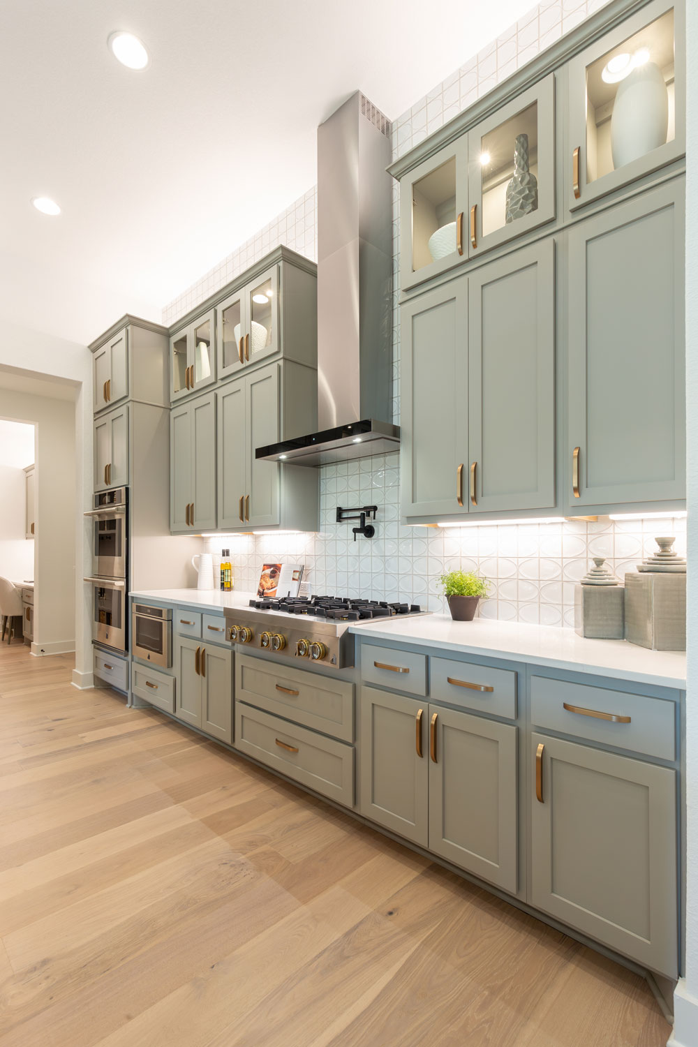 Kitchen with gray-green painted cabinets and Shaker style cabinet doors with OE4, IE2, and flat panel