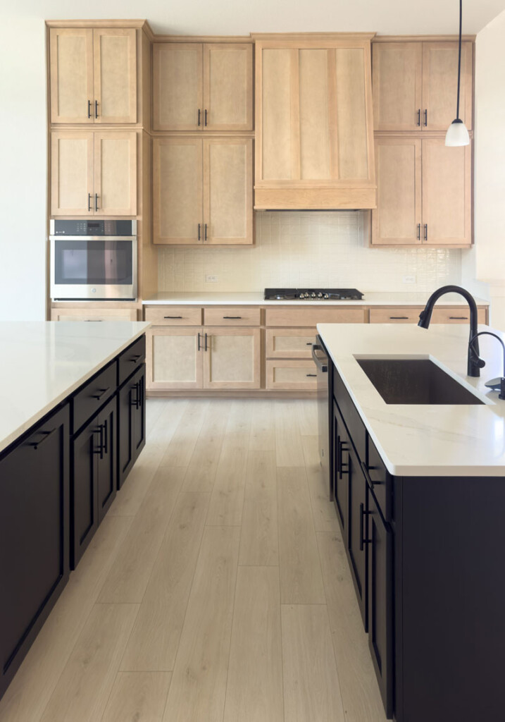 Kitchen with maple Shaker cabinet doors and black island base cabinets