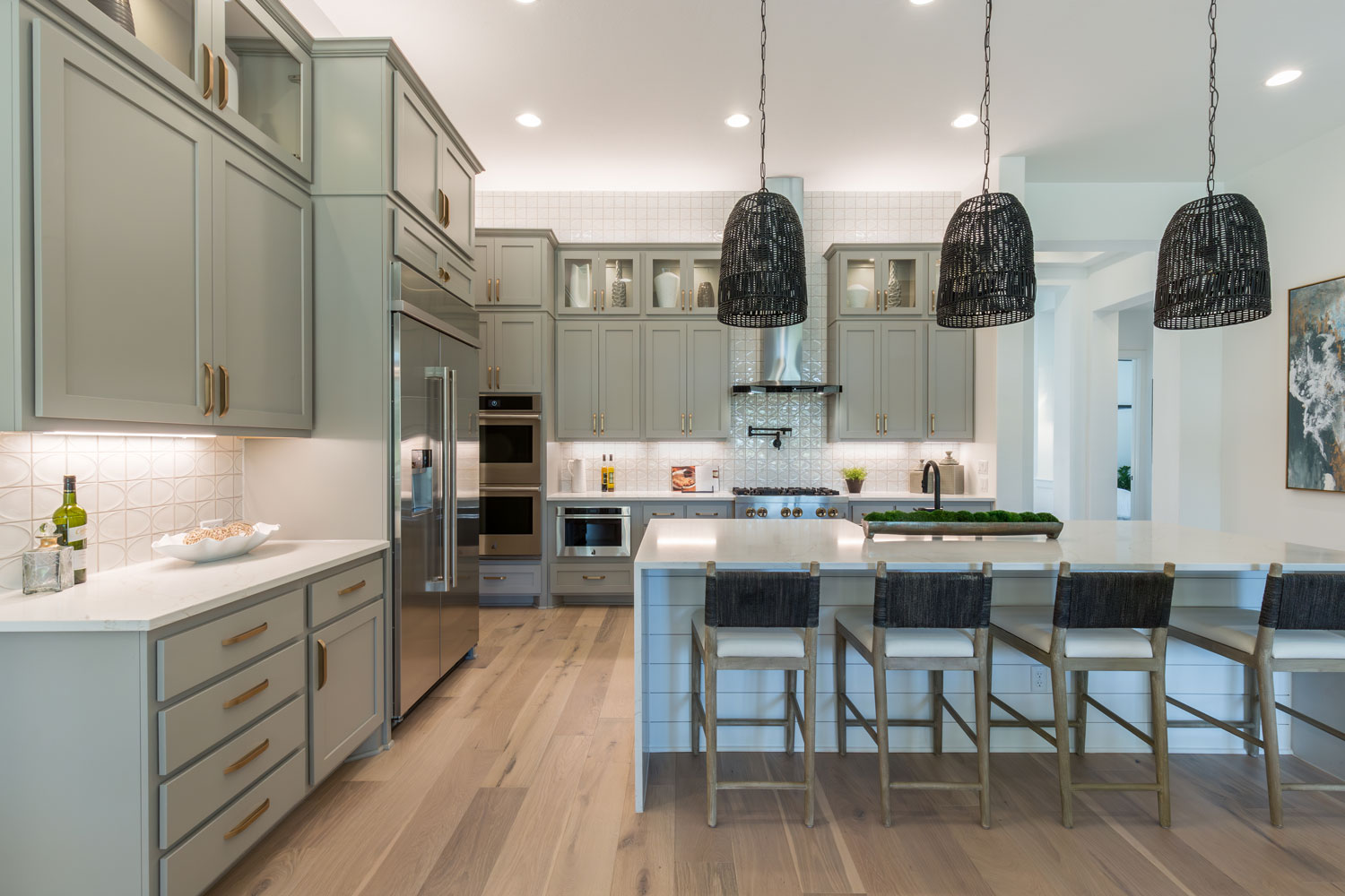 Kitchen with gray-green painted cabinets and Shaker style cabinet doors with OE4, IE2, flat panel