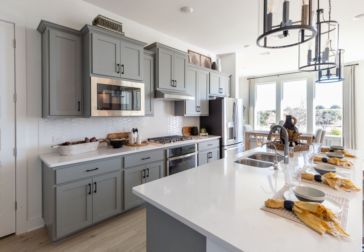 TaylorCraft's OE4, IE2, flat panel shaker cabinet doors in gray painted kitchen cabinets with yellow decor accents