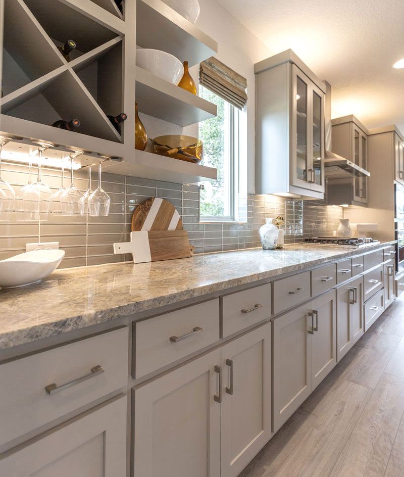 Transitional kitchen with painted shaker doors open shelves and x shaped bottle storage