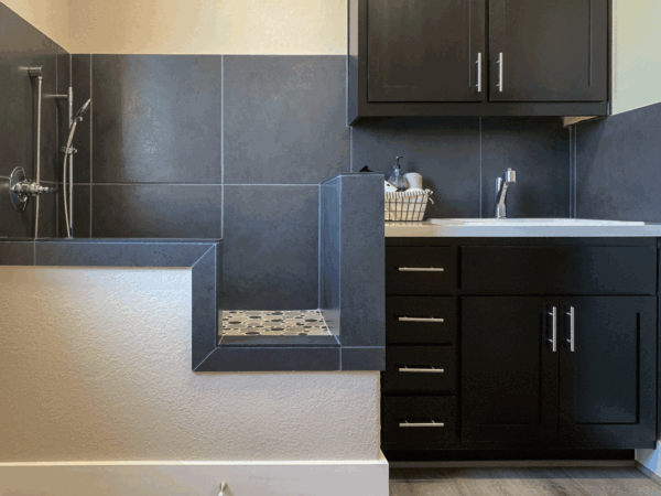 Laundry room dog shower with black paint grade shaker cabinet doors