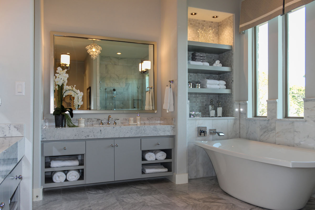 Modern slab paint grade cabinet doors in primary bathroom with soaking tub and open shelves