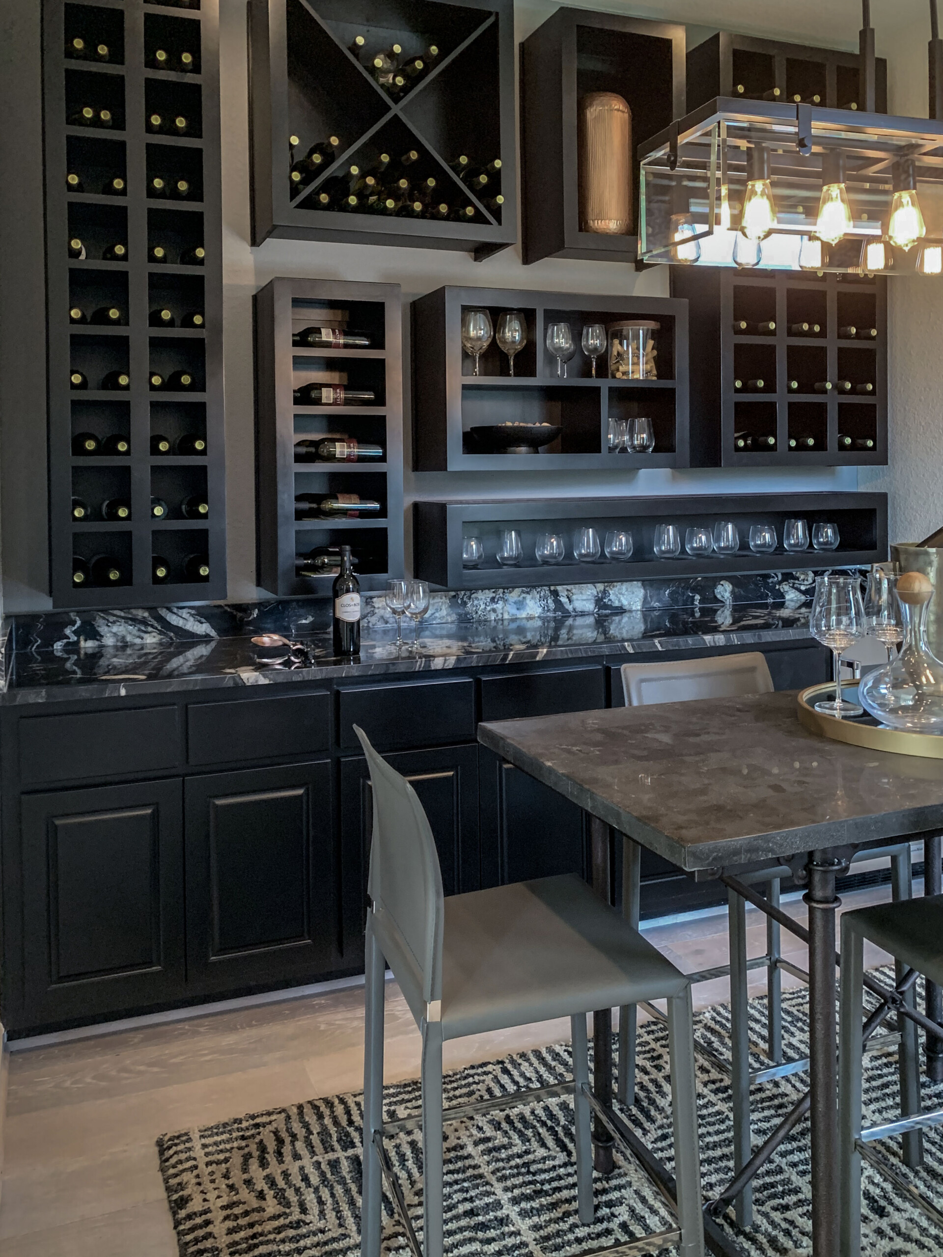 Wine room cabinets painted black with raised panel cabinet doors